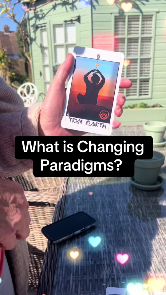 Jo holding the True North card in a garden: what is Changing Paradigms?